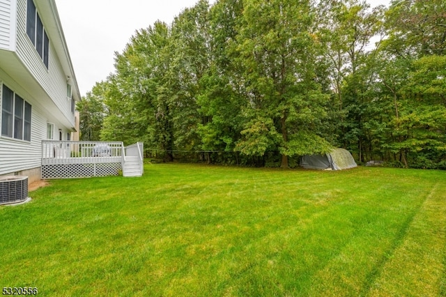 view of yard featuring central AC and a wooden deck