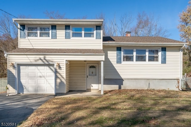 split level home featuring a garage and a front yard