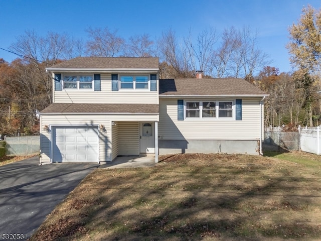 split level home with a front yard and a garage