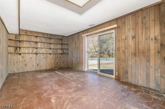 unfurnished room with wooden walls