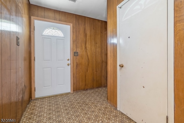 entrance foyer featuring wooden walls