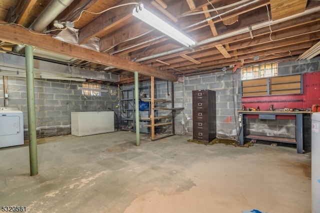 basement featuring a workshop area and washer / clothes dryer