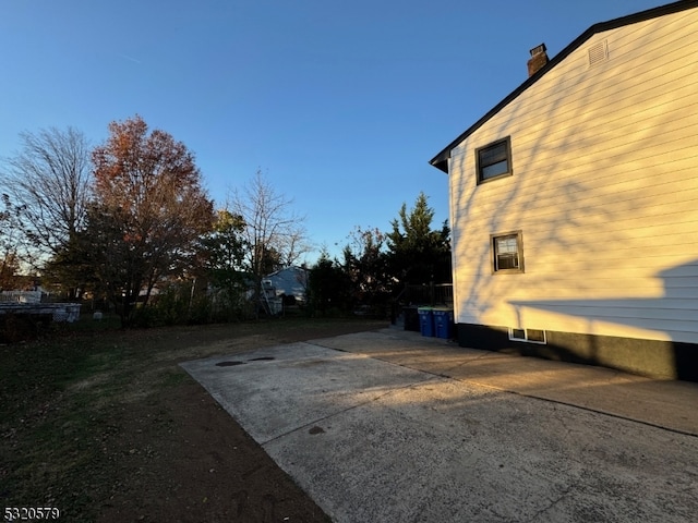 view of side of home featuring a patio area