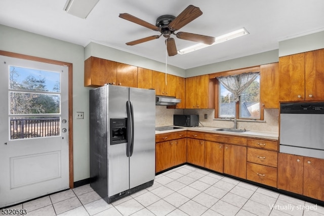 kitchen featuring light tile patterned flooring, sink, black appliances, ceiling fan, and decorative backsplash