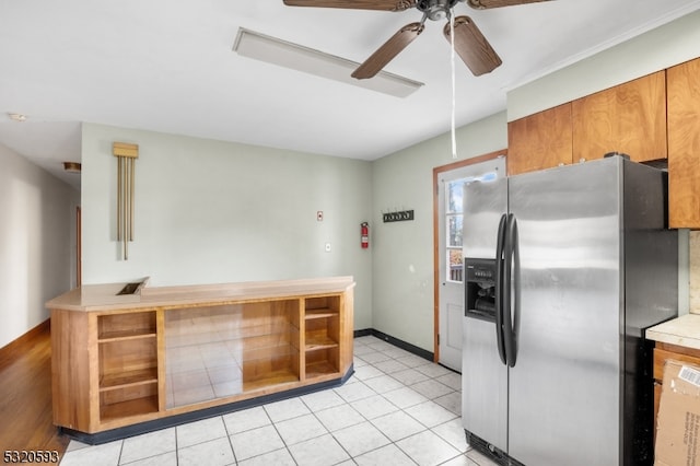 kitchen featuring ceiling fan, stainless steel fridge, and light tile patterned floors