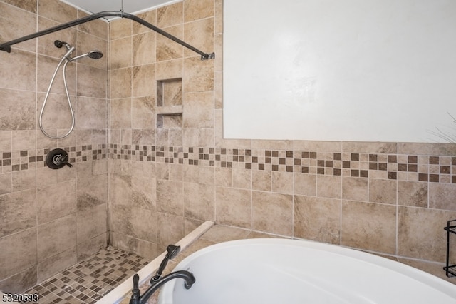 bathroom featuring separate shower and tub