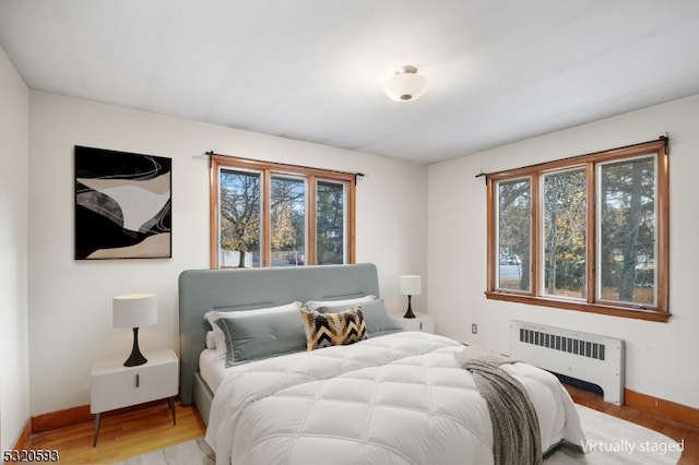 bedroom featuring radiator and wood-type flooring