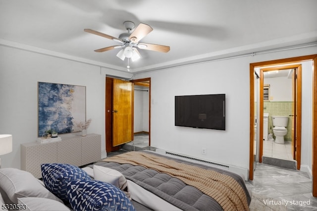 bedroom featuring baseboard heating, light tile patterned floors, ceiling fan, and ensuite bath