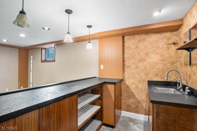 bar with hanging light fixtures and sink