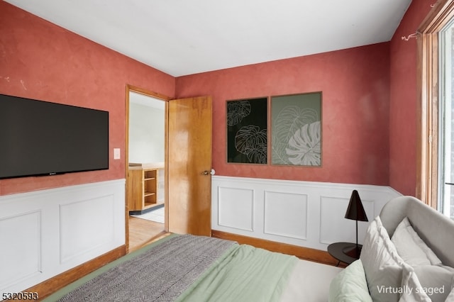 bedroom featuring light hardwood / wood-style flooring and multiple windows