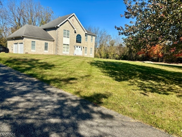 view of side of home with a lawn