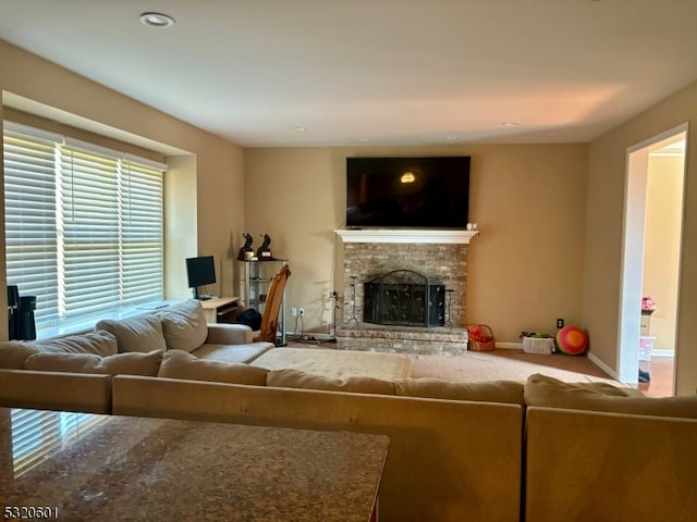 living room with a brick fireplace