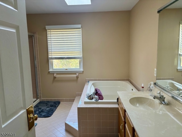 bathroom with vanity, tile patterned floors, plus walk in shower, and a skylight