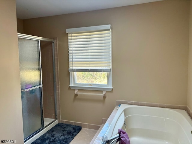 bathroom featuring tile patterned flooring and plus walk in shower