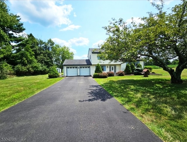 view of front of property featuring a garage and a front lawn