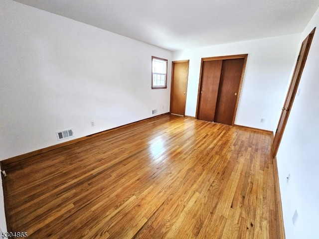 unfurnished bedroom featuring light wood-type flooring