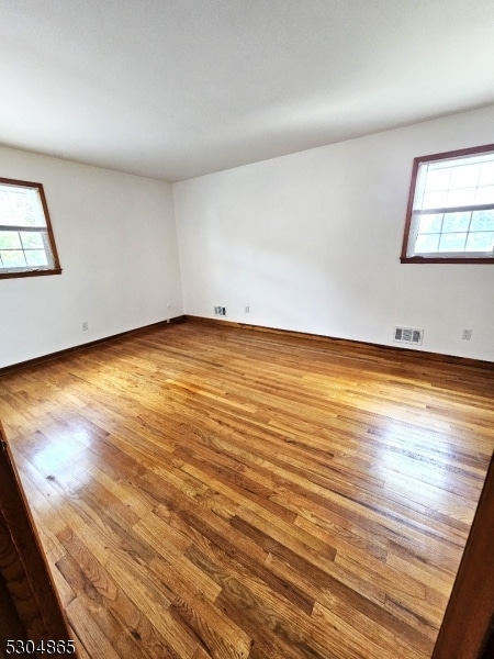 empty room with hardwood / wood-style flooring