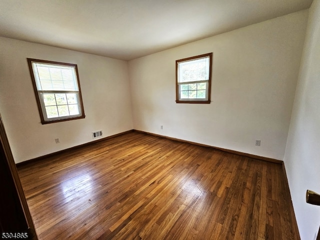 unfurnished room featuring dark wood-type flooring