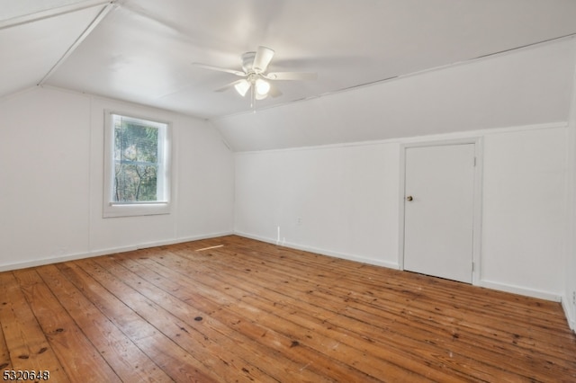 bonus room featuring lofted ceiling, hardwood / wood-style flooring, and ceiling fan