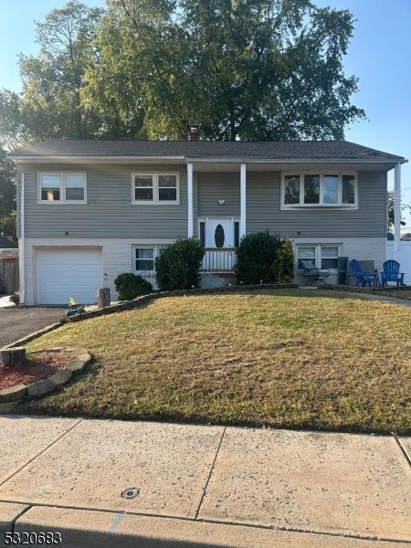 split foyer home with a front lawn and a garage