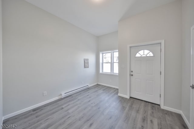 entryway featuring baseboard heating and light hardwood / wood-style flooring