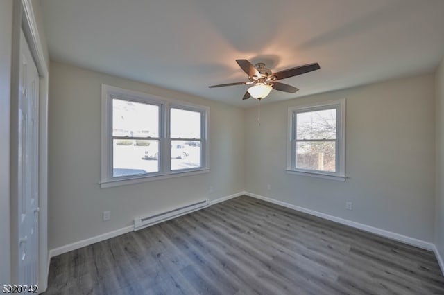 empty room featuring hardwood / wood-style floors, baseboard heating, and ceiling fan