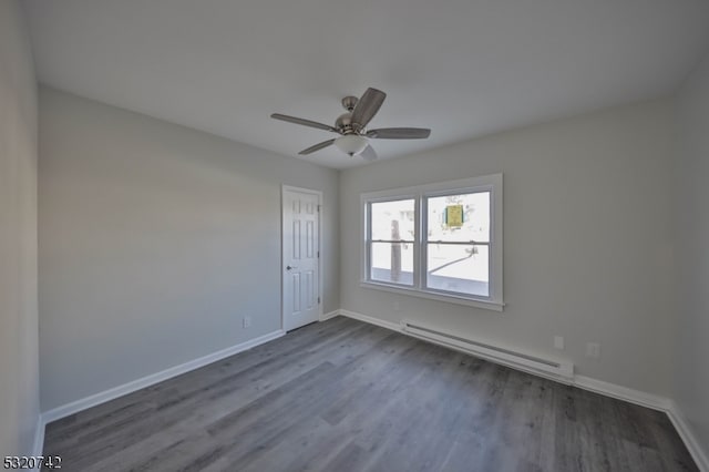 empty room with a baseboard heating unit, ceiling fan, and dark hardwood / wood-style flooring