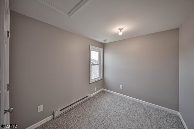 empty room with carpet floors and baseboard heating