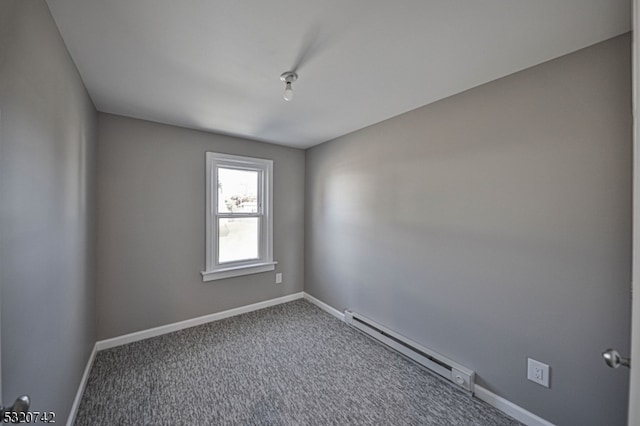 carpeted spare room featuring a baseboard radiator