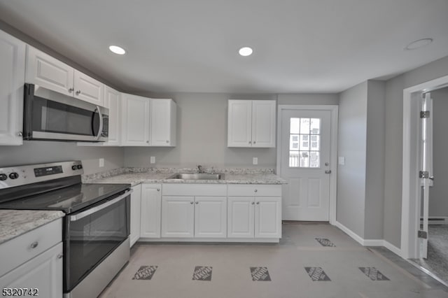 kitchen featuring white cabinets, stainless steel appliances, and sink