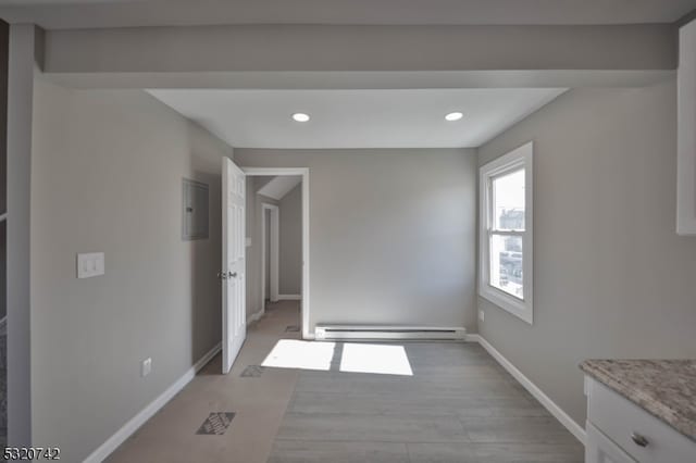 interior space featuring electric panel, a baseboard heating unit, and light wood-type flooring