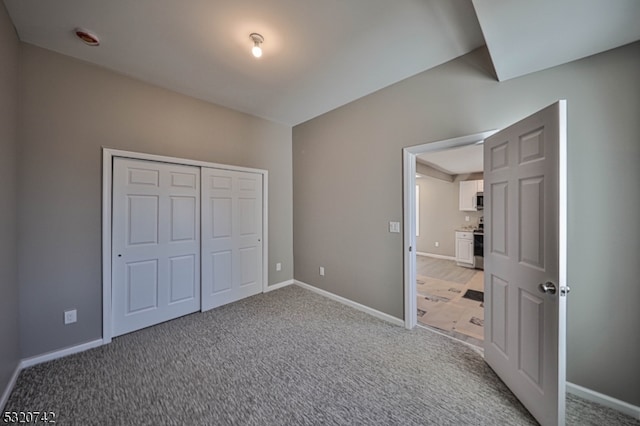 unfurnished bedroom with a closet and carpet