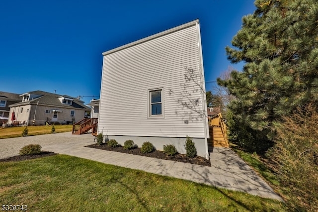 view of side of property with a yard