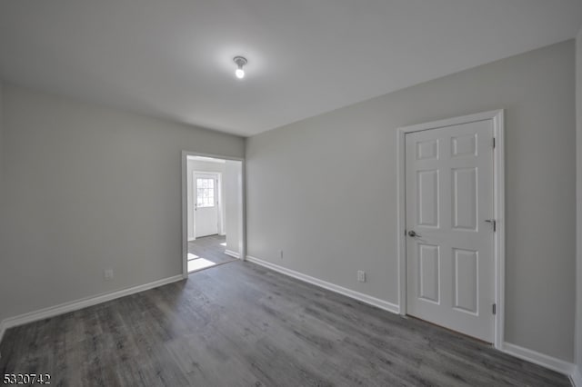 unfurnished room with dark hardwood / wood-style floors