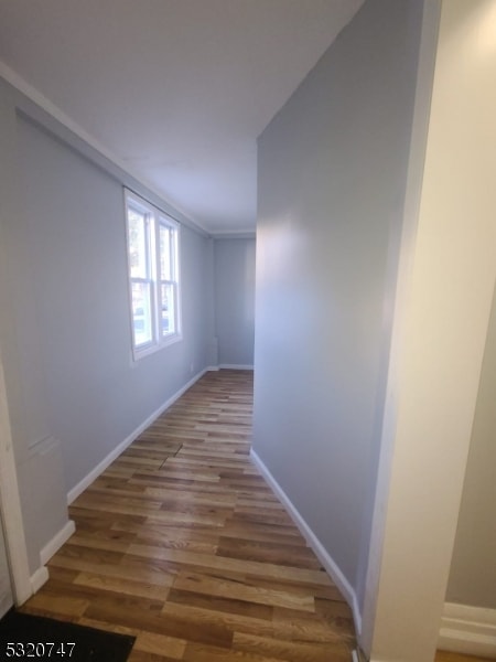 hall with hardwood / wood-style flooring