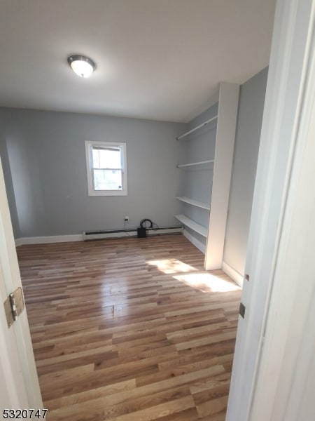 clothes washing area with light wood-type flooring