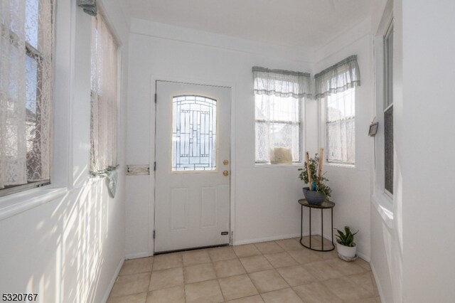 entryway with light tile patterned flooring