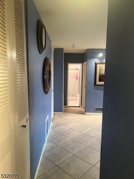 hall featuring light tile patterned flooring