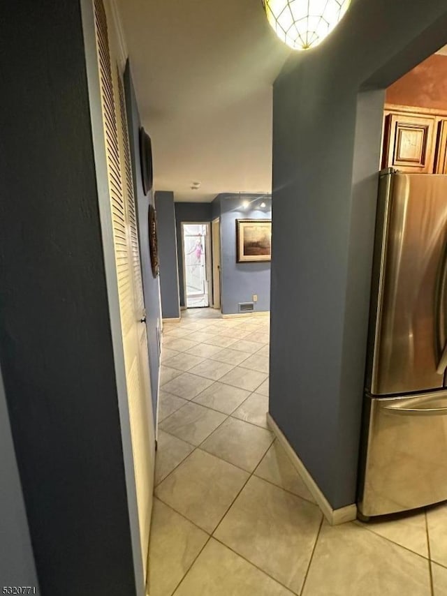 hall featuring light tile patterned floors