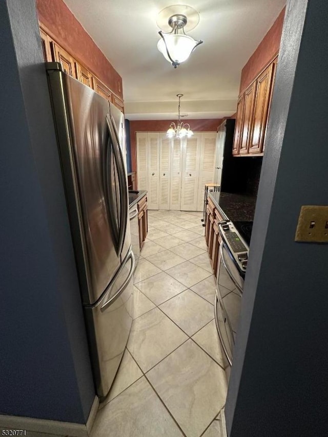 kitchen featuring a notable chandelier, light tile patterned flooring, and appliances with stainless steel finishes