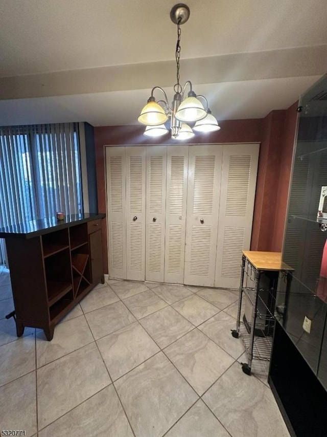 tiled dining area with an inviting chandelier