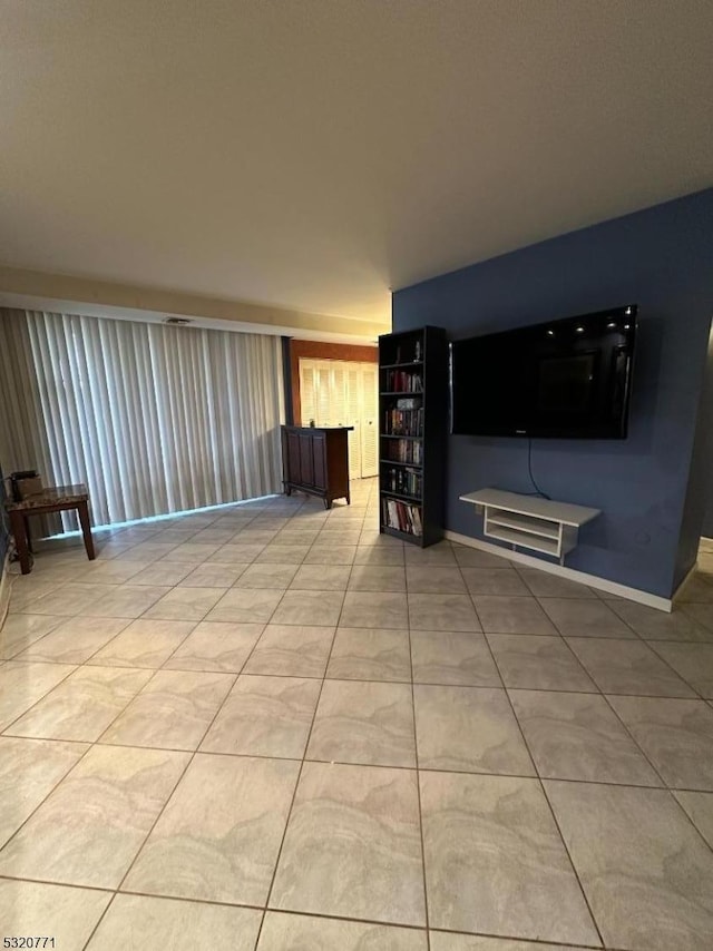 unfurnished living room featuring light tile patterned flooring