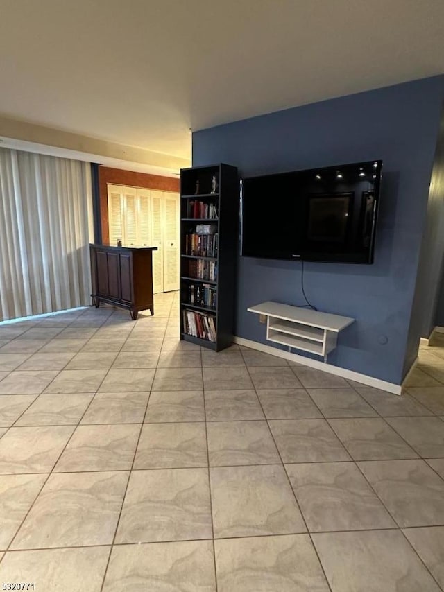 unfurnished living room with light tile patterned floors