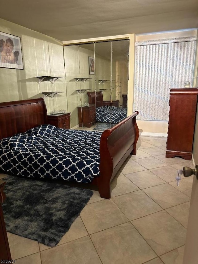 tiled bedroom with a closet