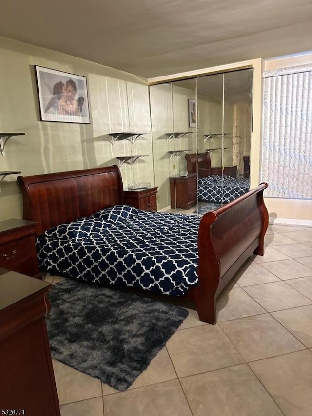 bedroom featuring light tile patterned floors and a closet