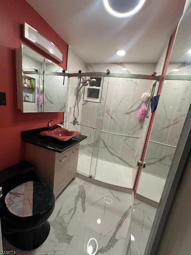 bathroom featuring vanity, toilet, and a shower with door