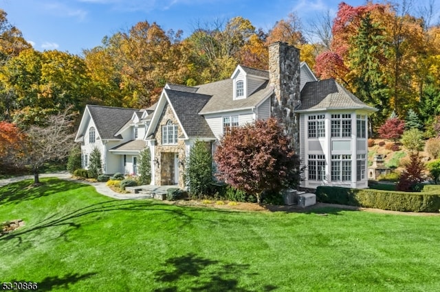 rear view of property featuring a lawn