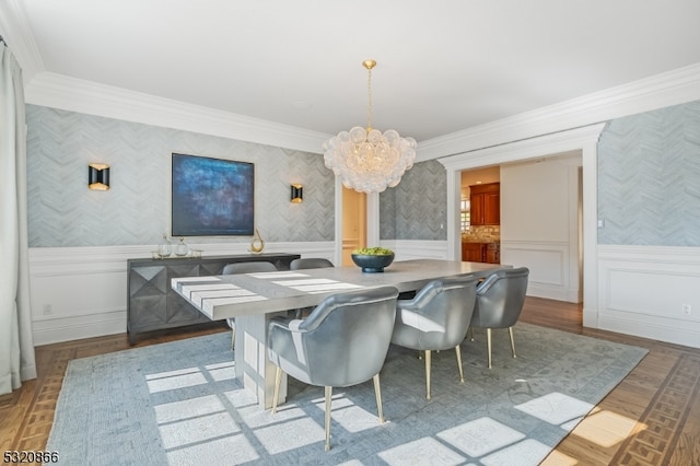 dining space featuring ornamental molding, a chandelier, and light wood-type flooring