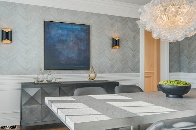 interior space with ornamental molding and an inviting chandelier