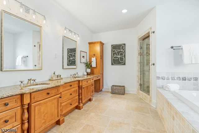 bathroom with vanity and separate shower and tub